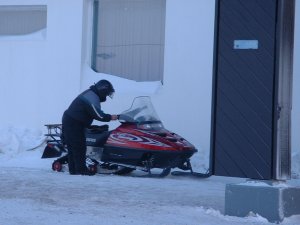 Staff arrive by snowmobile